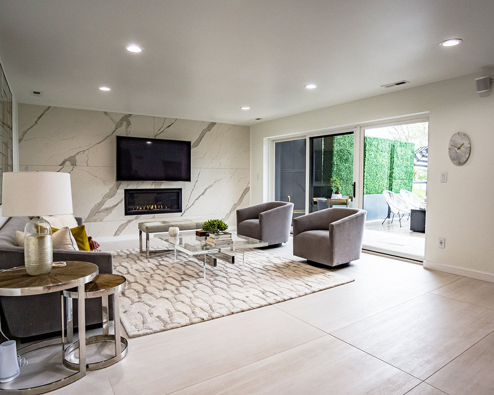Virginia Tile Laminam porcelain panels for the fireplace wall, Restoration Hardware vintage velvet furniture and William Sonoma Home acrylic coffee table.