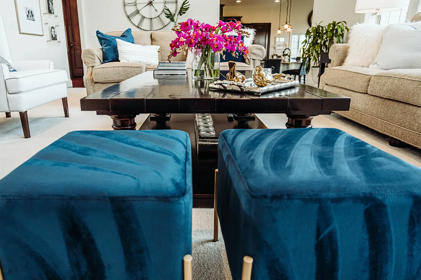 blue velvet ottomans in front of dark coffe table