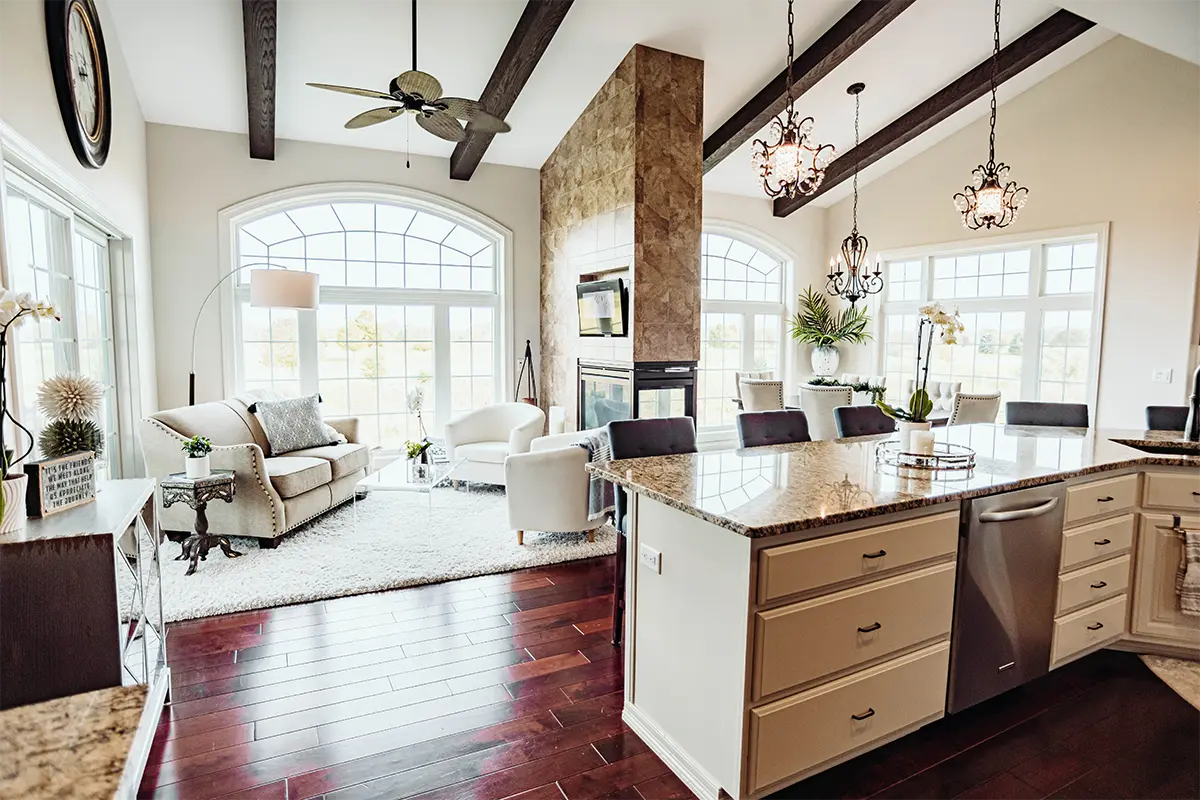 open floor plan living room and kitchen with tall beamed ceilings