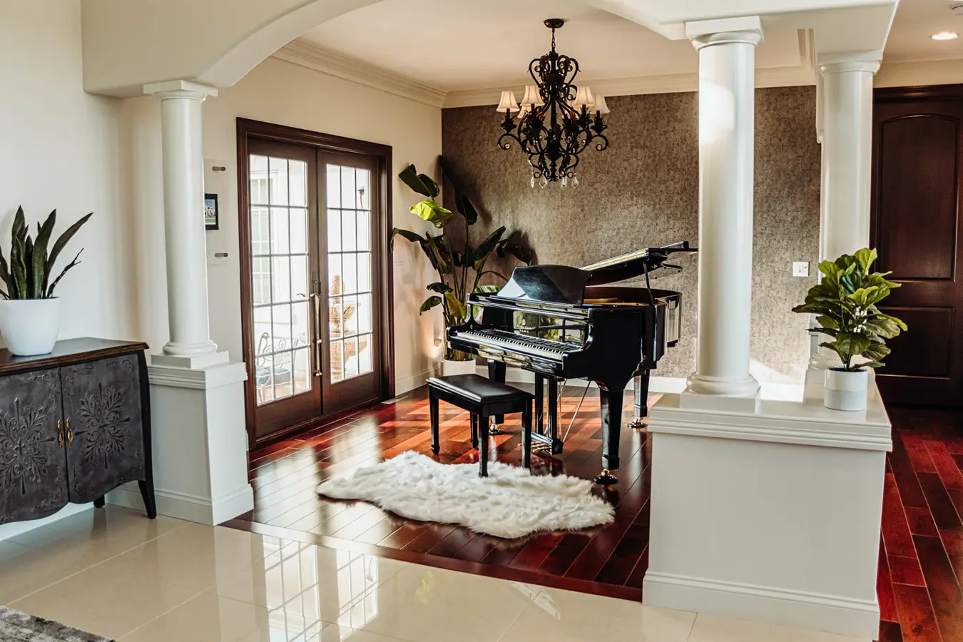 home entrance with grand piano and hardwood floors