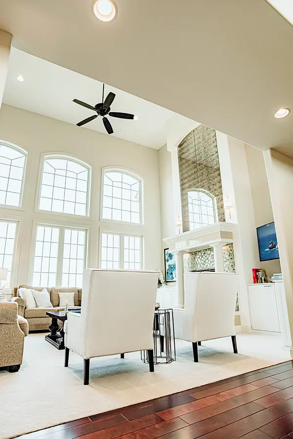 living room looking up at tall ceilings and ceiling fan